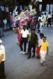 People in colourful costumes at the carnival parade in Port of Spain, Trinidad 1963 with the title Freedom of the Road march