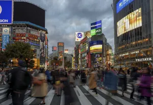 People cross the Shibuya crossroads