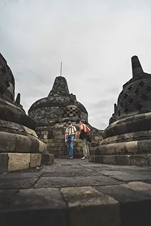 People exploring the stupas in an ancient temple complex