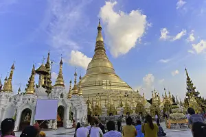 People gather to pray at a famous pagoda under a blue sky