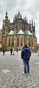 People looking at Saint Vitus Cathedral standing within Prague Castle