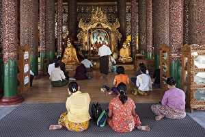 Category Buddhism Prints: People meditating in front of Buddha statues