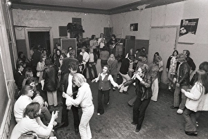 This is how people partied in the 1970s. People dance and drink beer while a band plays live music. Women and men dance to the music, drink beer and smoke in a rather dull party room that everyone somehow seems to enjoy and have fun in. 1970