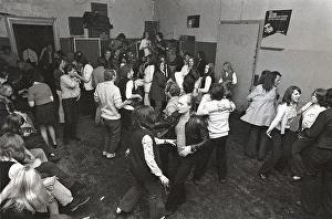 This is how people partied in the 1970s. People dance and drink beer while a band plays live music. Women and men dance to the music, drink beer and smoke in a rather dull party room that everyone somehow seems to enjoy and have fun in. 1970