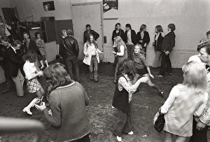 This is how people partied in the 1970s. People dance and drink beer while a band plays live music. Women and men dance to the music, drink beer and smoke in a rather dull party room that everyone somehow seems to enjoy and have fun in. 1970