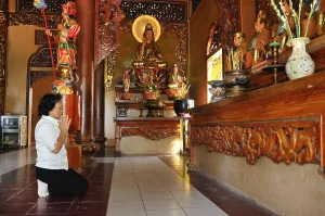 People praying in a Buddhist temple on the mountain of the black woman