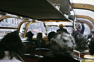 People sitting inside boat trip tour through the city centre Amsterdam, Netherlands 1973 Tour guide microphone commentary
