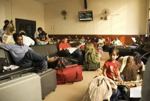 People sitting in waiting room of railway station