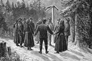 People standing in a circle around a station of the Stations of the Cross