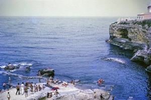 People sunbathing on rocky coastal ledge by Mediterranean Sea, Syracuse, Sicily, Italy, Europe 1969, Europe