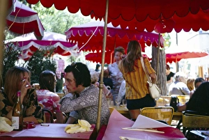 People at the tables of a street cafe on Montnartre, Paris, France 1970