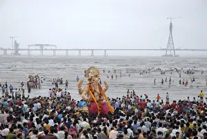 People taking huge lord ganesha idol for immersion at Chowpaty