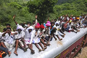 People taking risk while travelling on roof of train