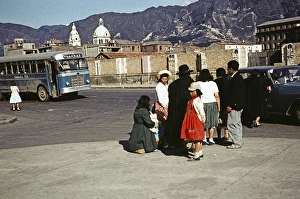 People taxi and bus on the street in the city centre, Bogota, Colombia, South America, 1961 with the caption ss being near the train station, South America