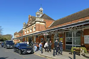 People and taxis outside Colchester North mainline railway station building