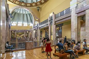 People viewing artwork murals inside Palacio de Bellas Artes
