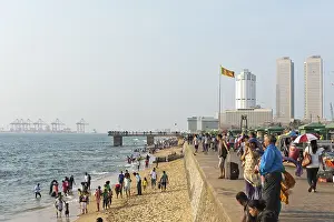 People walk along the beach promenade
