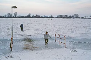 People walk across ice rink, ferry dock
