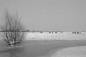 People walk across ice rink, frozen Elbe