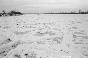 People walk across ice rink, frozen Elbe