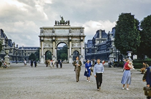 People walking around the Arc de Triomphe du Carrousel, Paris, France 1956