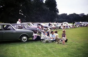 People watching a polo match Cirencester, Gloucestershire, England, UK 1967, sitting by their cars