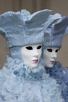 Two people wearing ice-blue costumes and masks