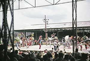 Performers in colourful costumes on stage as part of carnival celebrations, Port of Spain, Trinidad 1962 - captioned as Nature's Notebook