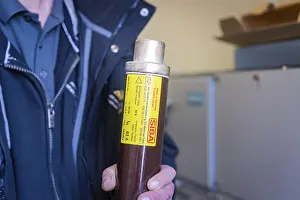 Category Historic EN Prints: Person holding a fuse with SIBA label focussed on electrical safety