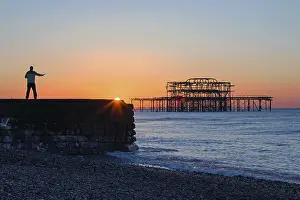 Person practicing Tai Chi at sunrise near West Pier