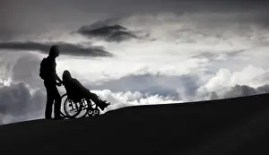 Person pushing a wheelchair, care for the elderly