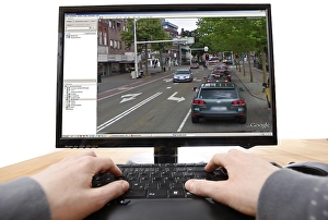 Person sitting at a computer working with Google Street View