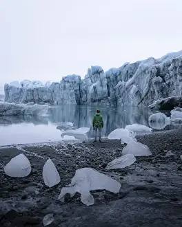 Person standing in front of a glacier lagoon