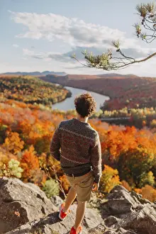 A person stands on a rocky overlook
