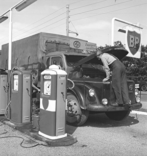 Petrol station in the olden days. Here, a truck driver from the company ASG has stopped and opened the hood of his Volvo truck. The petrol station belongs to the English petroleum company BP (British Petroleum)