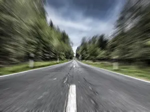 Photo with speed effect high speed speeding without speed limit from country road with central reservation leading to