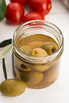 Pickled olives and olive tree branch