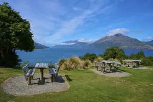 Framed Print : Picnic tables with a view of a lake and mountains below Framed Print : Picnic tables with a view of a lake and mountains below