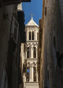 A picture of Saint Domnius Cathedral's tower between two building facades<br> A picture of Saint Domnius Cathedral's