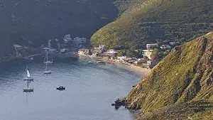 A picturesque coastal village with boats on a sunny evening