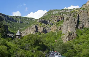 A picturesque gorge with steep rock faces and lush greenery