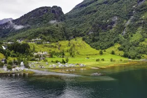 Picturesque landscape with green mountains and camping site along a fjord