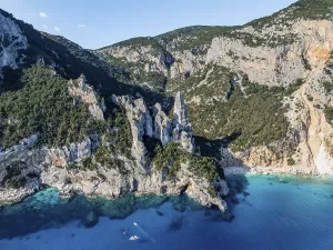 Picturesque rocky coast, cliffs with L'Aguglia pinnacle