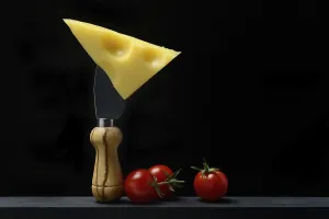 A piece of Swiss Emmental cheese on a cheese knife