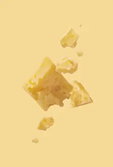 Pieces of cheese on a yellow background