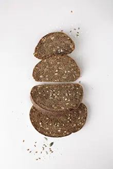 Pieces of rye bread with seeds, flat lay