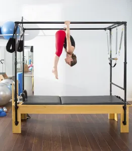 Pilates aerobic instructor woman in cadillac fitness exercise