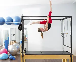 Pilates aerobic instructor woman in cadillac fitness exercise