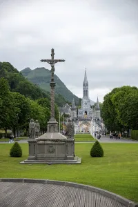 Many pilgrims visiting the Sanctuary of Our Lady of Lourdes on a beautiful spring day