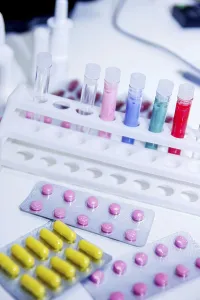 Pills and lively colored test tubes in a scientific laboratory